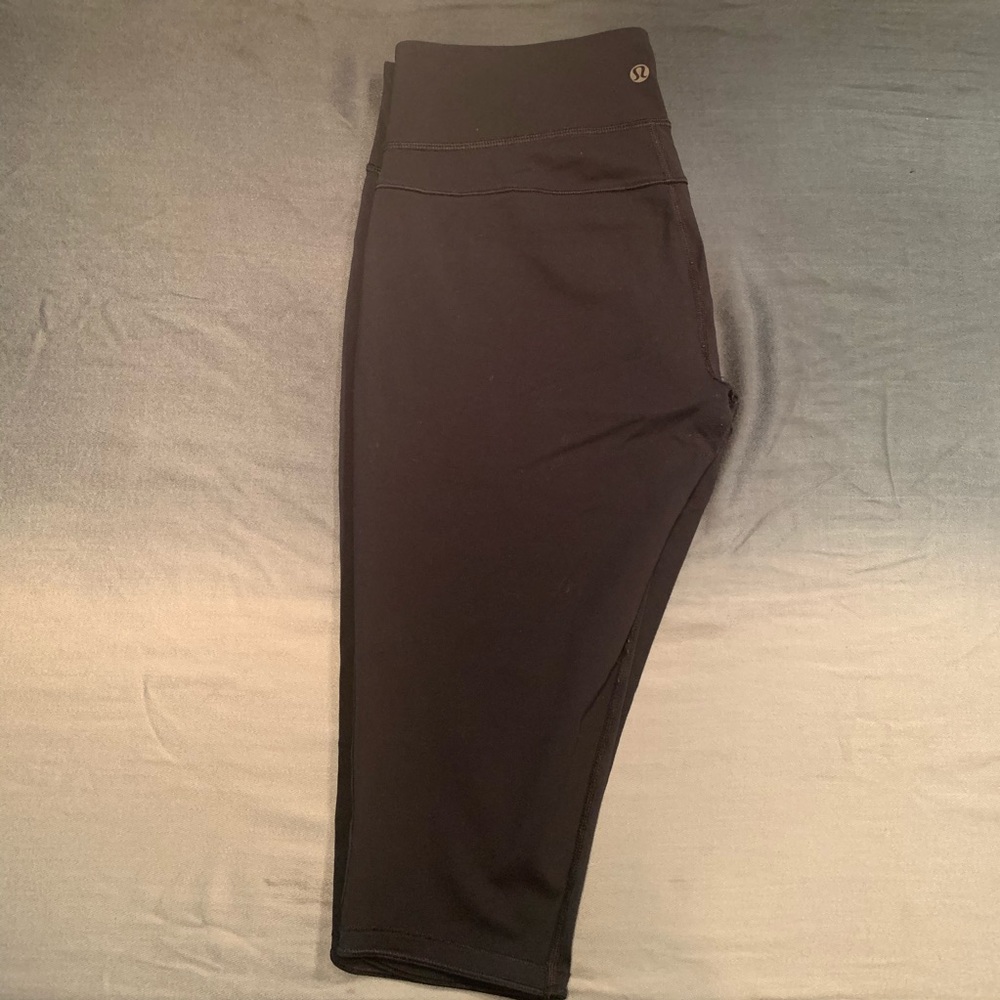 Black Lululemon thigh high tights (leggings).